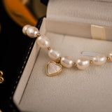 Elegant Pearl Bracelet with Gold-Tone Heart Charm