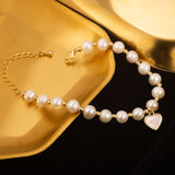 Elegant Pearl Bracelet with Gold-Tone Heart Charm