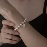 Elegant Pearl Bracelet with Gold-Tone Heart Charm